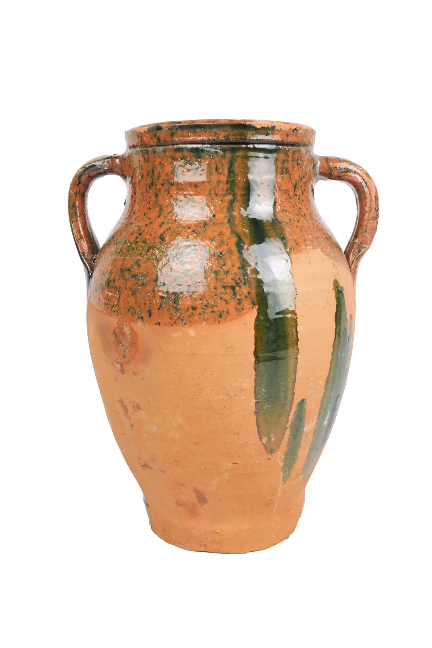 An Antique Olive Pot hand made from terracotta with splashes of dark green glaze.