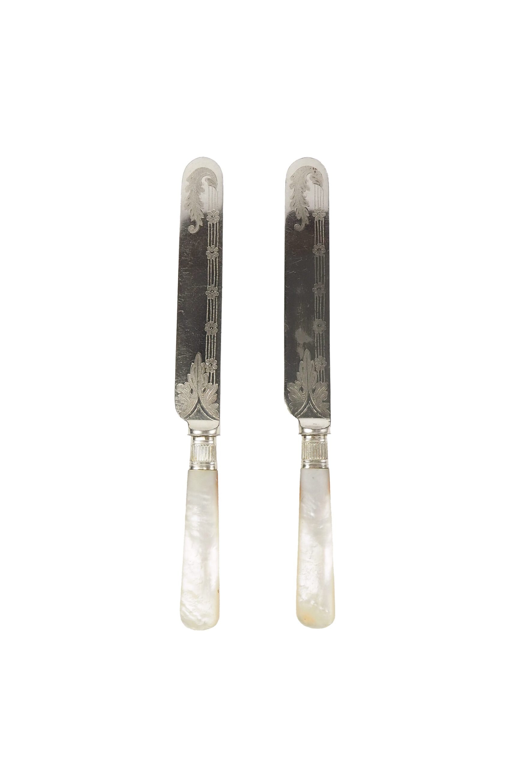 A Pair of Antique Silver Plate Knives with mother of pearl handles. Each knife has a blade with a beautifully etched floral pattern. Sourced for Wildmore