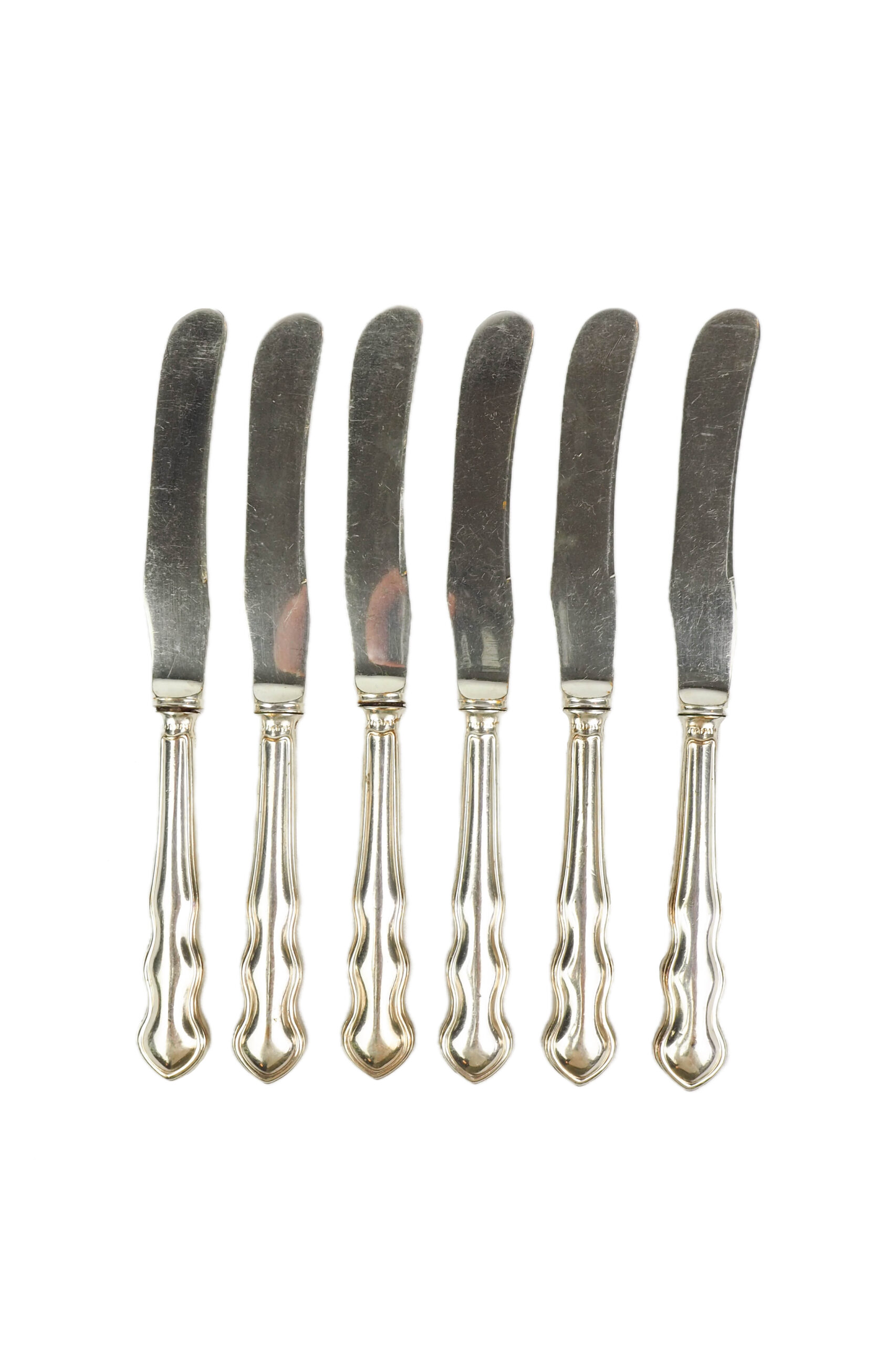 An Antique set of six Silver Plate Butter Knives with shapely tactile handles.